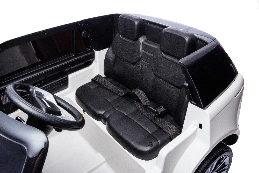 Interior view of the Red 24V Range Rover SUV ride-on toy, featuring two black eco-leather seat benches, seatbelts, and a steering wheel. The car showcases a sleek design with its officially licensed Range Rover features against a white backdrop.