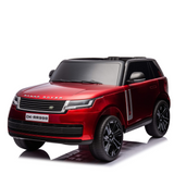 The Red Metallic 24V Range Rover Ride-On SUV features dual seating, a glossy finish, black tinted windows, black EVA wheels with silver accents, and a DK-RR998 license plate. Officially licensed and set against a white background, it includes parental control for added safety.