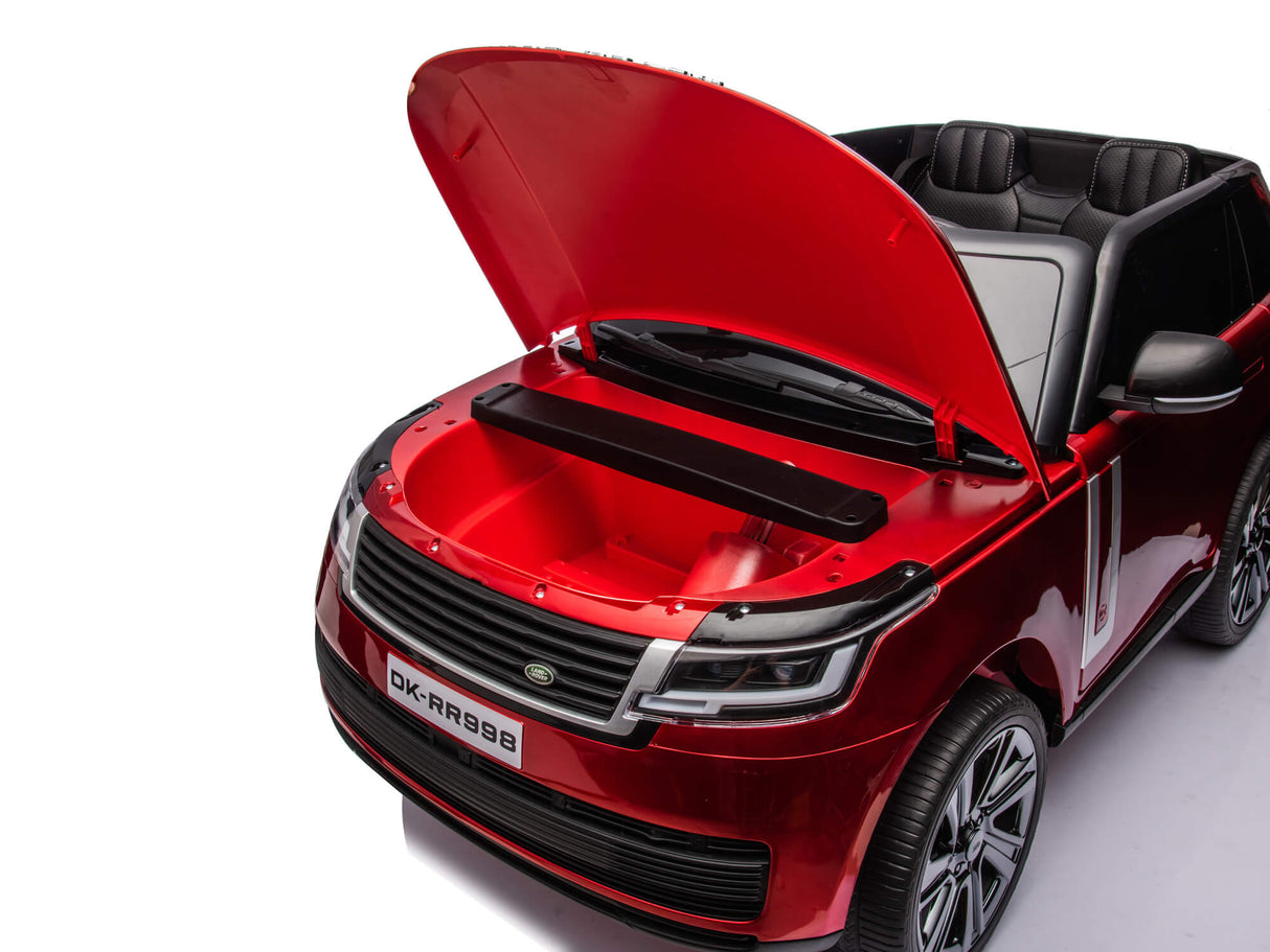 The Red Metallic 24V Range Rover Ride-On SUV, modeled as an officially licensed Range Rover, features an open hood with an empty compartment, black dual seating, a windshield, detailed headlights on a white backdrop, and a license plate reading DK-RR999.