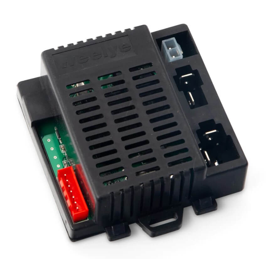 The black rectangular receiver for the 12V/2 Seater Tundra, with ventilation slits and red and blue connectors, features a visible circuit board. Designed for easy installation, it is set against a plain white background to enhance ride-on car performance.