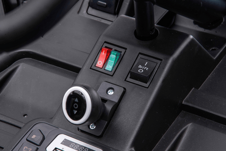 A close-up of the Red 24V Ultra-Violent Big Kids Complete Edition Drifting Go-Karts control panel reveals two switches—red and green—a Drift switch, a circular socket, and a digital display screen with numbers, all set against a dark background.