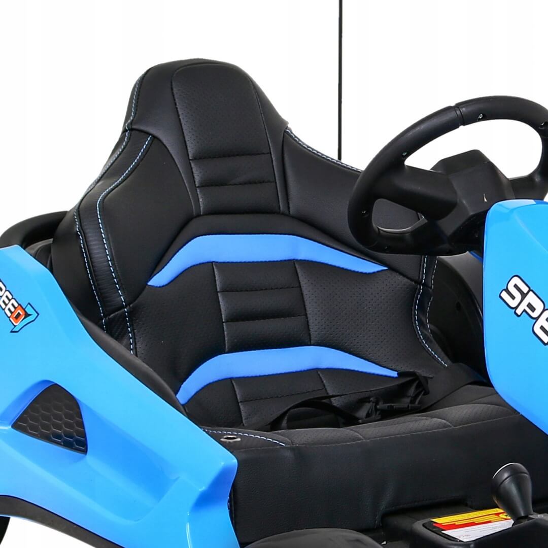 Close-up of a blue racing seat and steering wheel on the Blue Big Kids 24 Volt Ultra-Violent Complete Edition Drifting Go-Kart, featuring blue accents, a safety harness, and SPEED on the exterior, promising high-speed drifting fun with EVA-rubber wheels for enhanced grip.