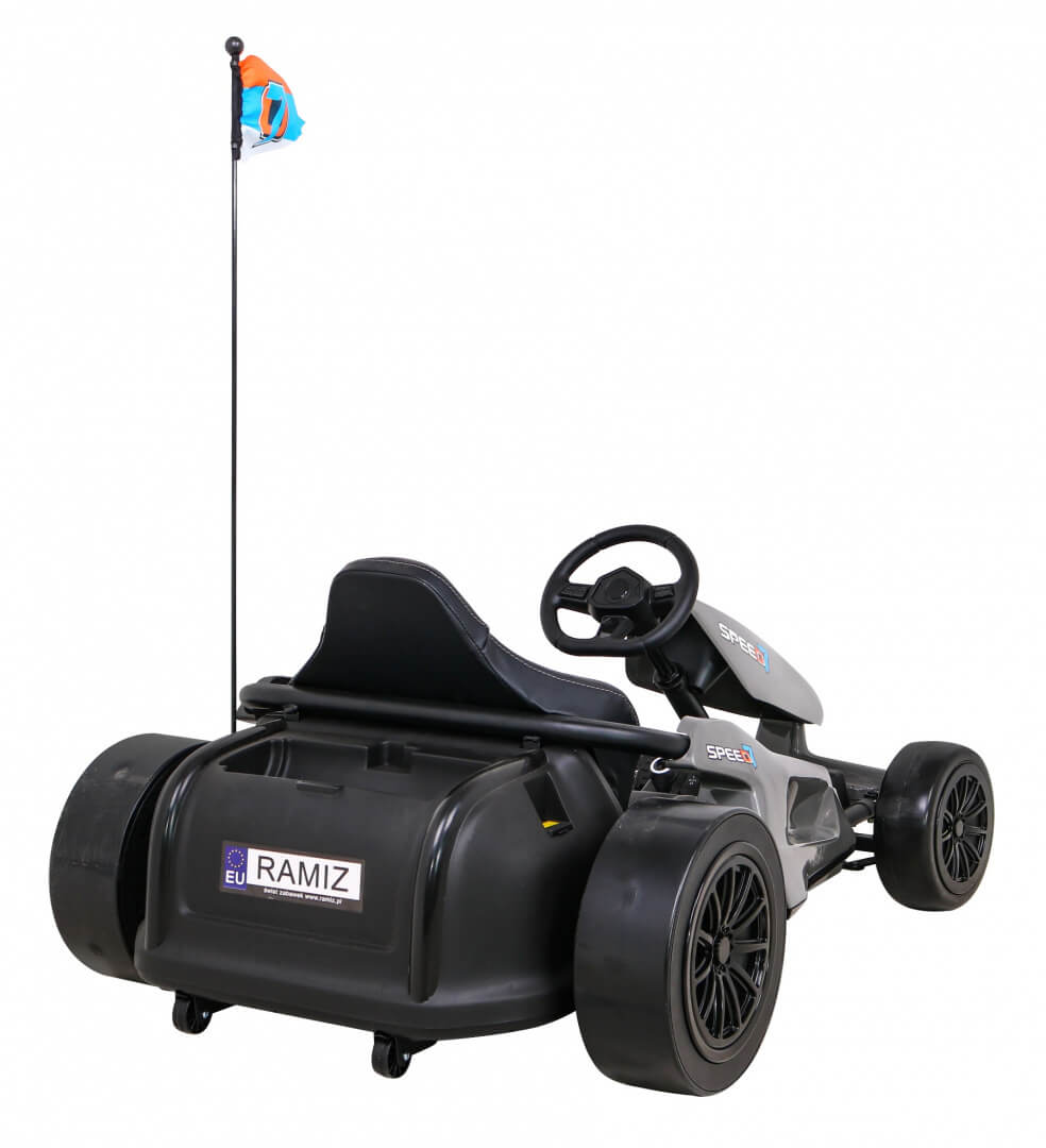 The Grey Big Kids 24V Ultra-Violent Complete Edition Drifting Go-Kart boasts a sleek design with a seat, steering wheel, four wheels, rear spoiler, and vertical flagpole adorned with a blue flag. Featuring Ramiz decals on the back, its perfect for thrilling drifts.