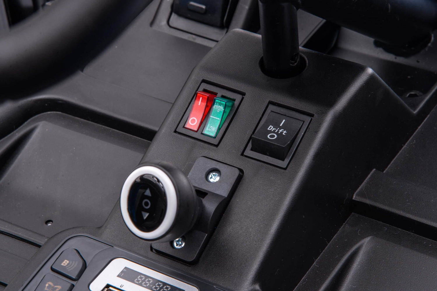 Close-up of the Grey Big Kids 24V Ultra-Violent Complete Edition Drifting Go-Karts dashboard with red and green toggle switches, a round ignition button, and a Drift button with I and O settings. Its sleek black design complements the powerful motors.