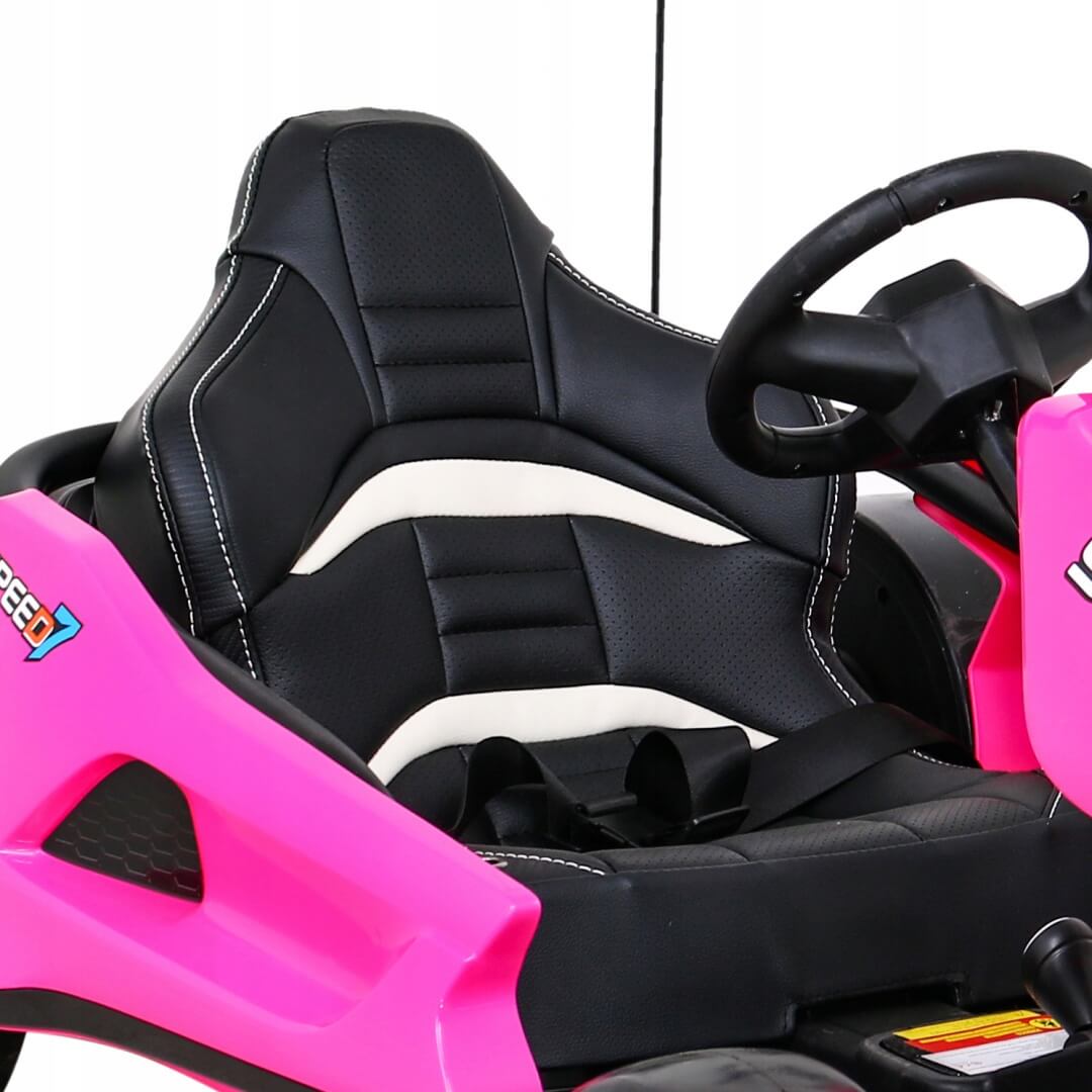 A close-up shot features a black and white go-kart seat with a seatbelt in the pink frame of the Pink 24V Ultra-Violent Big Kids Complete Edition Drifting Go-Kart. The partially visible steering wheel highlights its sporty design, including stitching accents—ideal for thrilling drifting adventures.