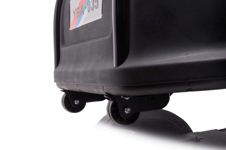 A close-up of the bottom corner of a black garbage bin with two small wheels resembles the Red 24V Ultra-Violent Big Kids Complete Edition Drifting Go-Kart. A blurred license plate in the background adds mystery against a plain white backdrop, highlighting its simplicity.