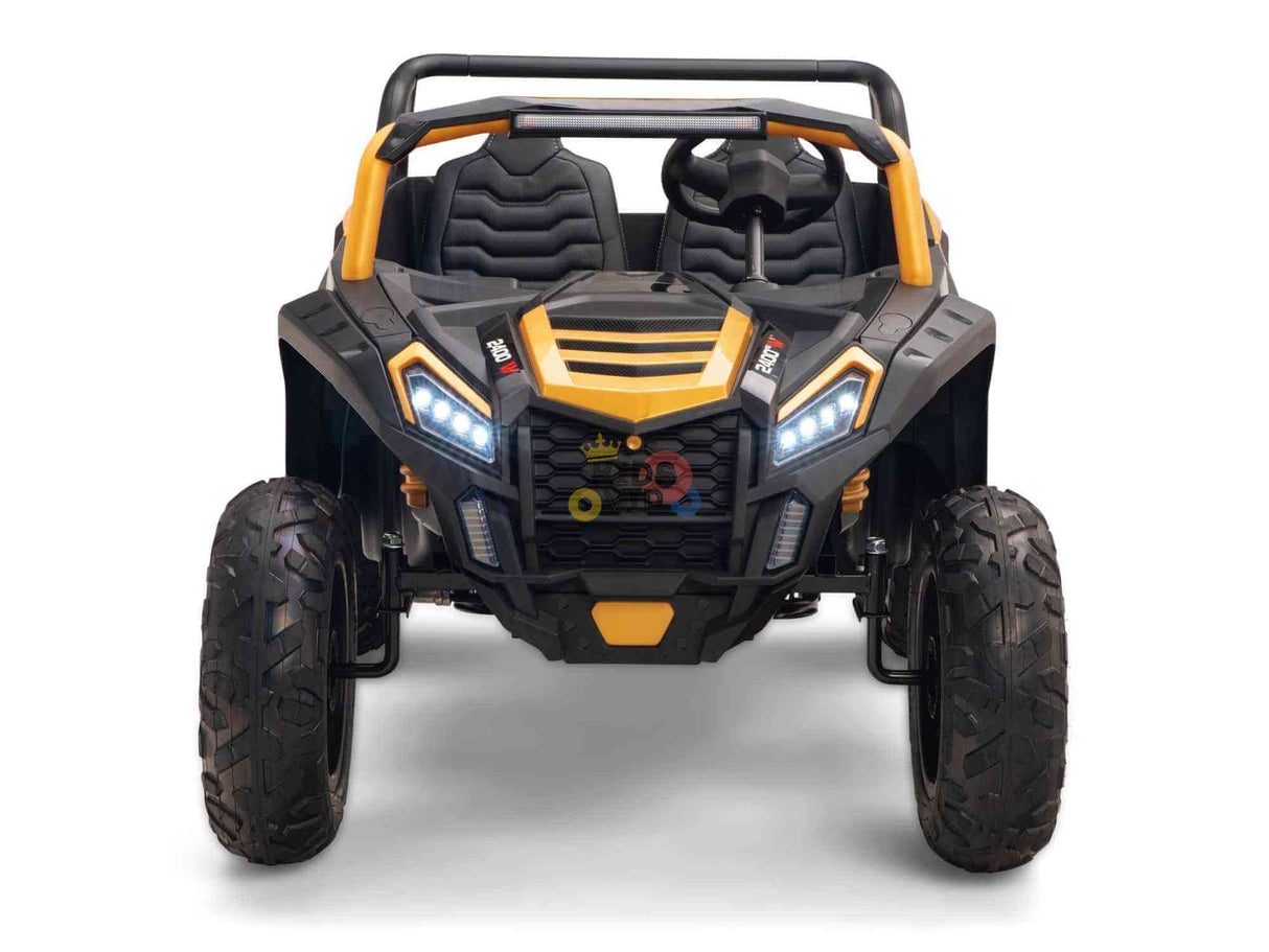 A front view of the Gold 2 Seater XXL Blade XR Edition, a yellow and black ride-on buggy with large tires and roll cage. It features two high-back seats, detailed graphics, LED headlights, and a rugged 24V 180W design resembling an off-road vehicle.