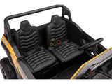 The Gold 2 Seater XXL Blade XR Edition 24V 180W Ride On Buggy UTV, designed for children, features two black seats with seat belts, a steering wheel, and an interior with molded stitching and textured surfaces for an authentic ride.