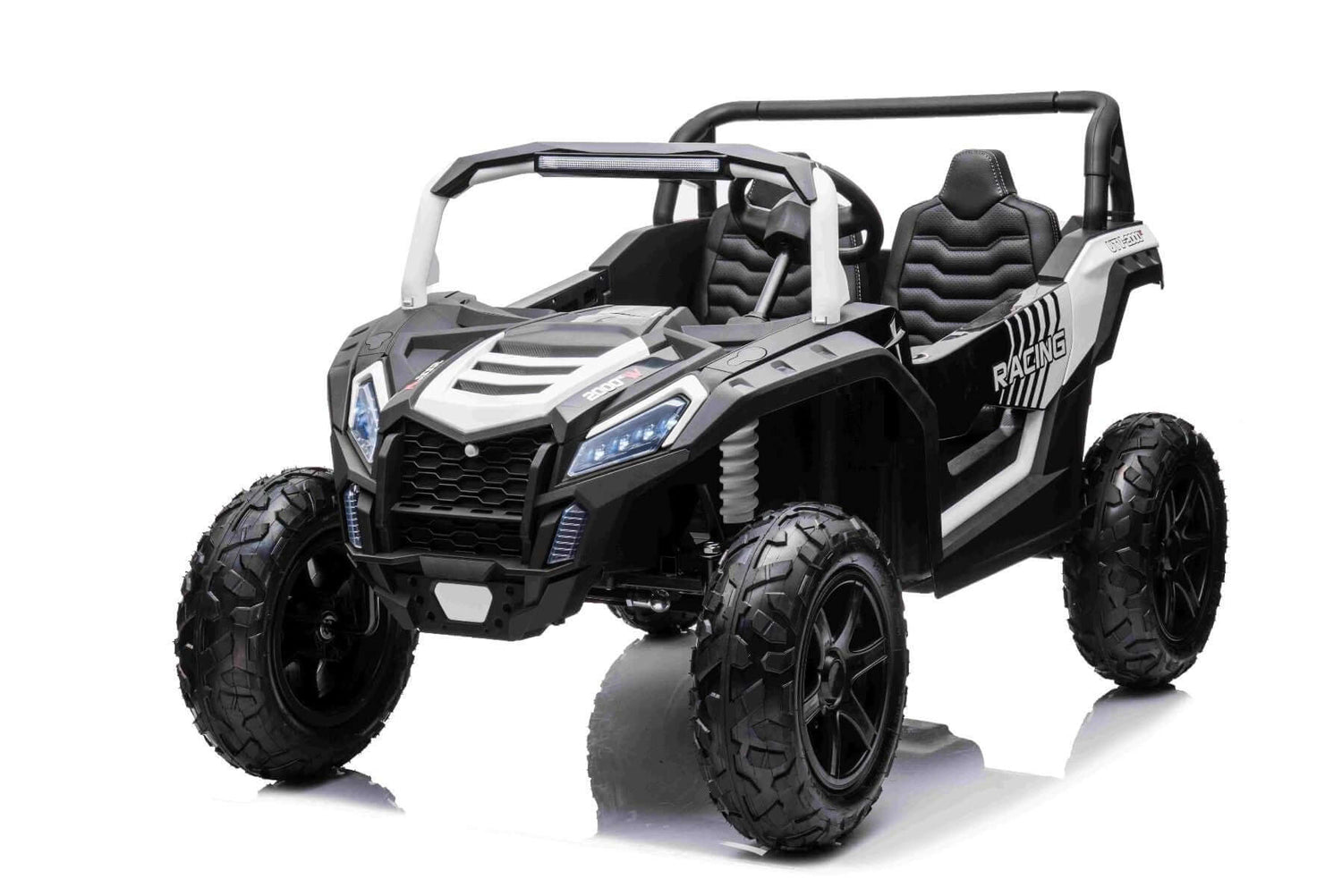 The White 24V/180W XXL Big Kids Blade XR Ride on Buggy is a black and white toy car with large inflatable rubber tires, detailed grille, open sides, two padded seats, and a roll bar. It boasts sporty aesthetics set against a plain white background.