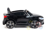 The Black Licensed BMW GT 12V Kids Ride On Power Car with Remote Control is a sleek black toy sports car featuring upgraded design elements, including a shiny exterior, detailed features, a small seat, steering wheel, and realistic wheels and headlights for an authentic driving experience.