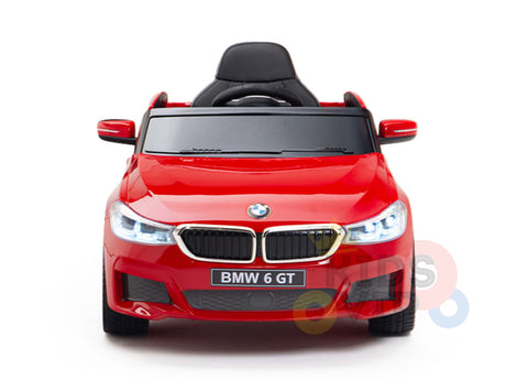 The Red 12V BMW GT Kids Licensed Ride On Car, featuring a black seat and shining headlights, is set against a pristine white background.