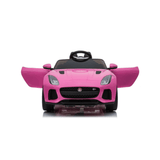 The Pink 12V Official Jaguar F-Type Complete Edition Kids Ride-on Car showcases a sleek design from the front, with open doors revealing a black interior and leather seats, plus a steering wheel. Its displayed on a reflective surface.