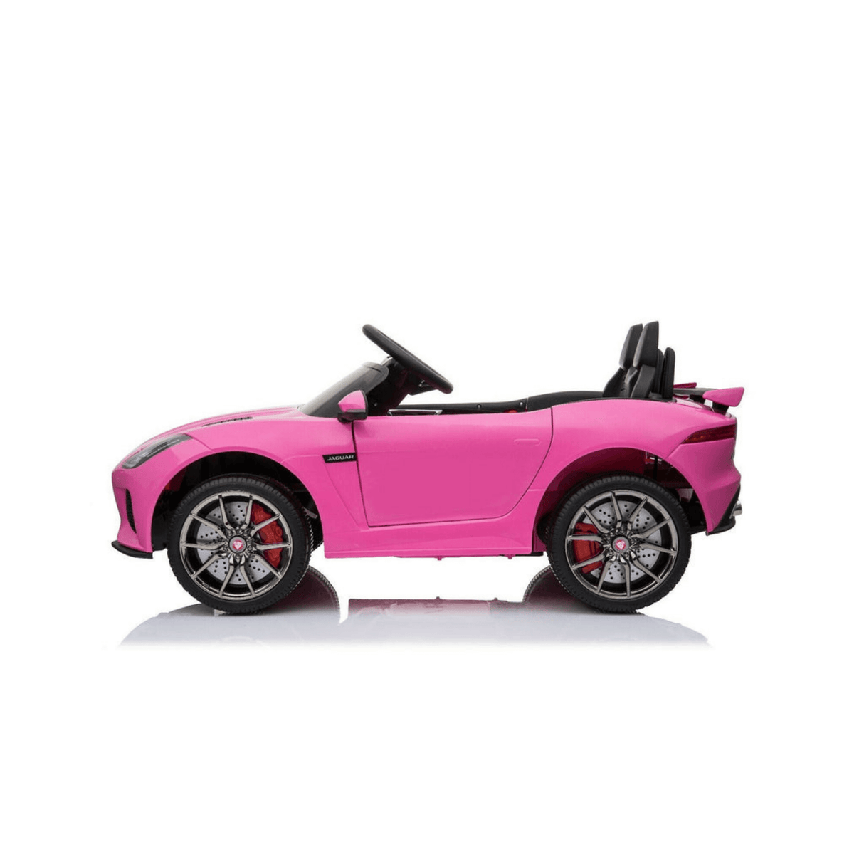 The Official 12V Jaguar F-Type Complete Edition Kids Ride-On Car in pink showcases a sleek design with black interior and red brake calipers. It includes a powerful 12V battery and parental remote, pictured from the side on a plain white background.