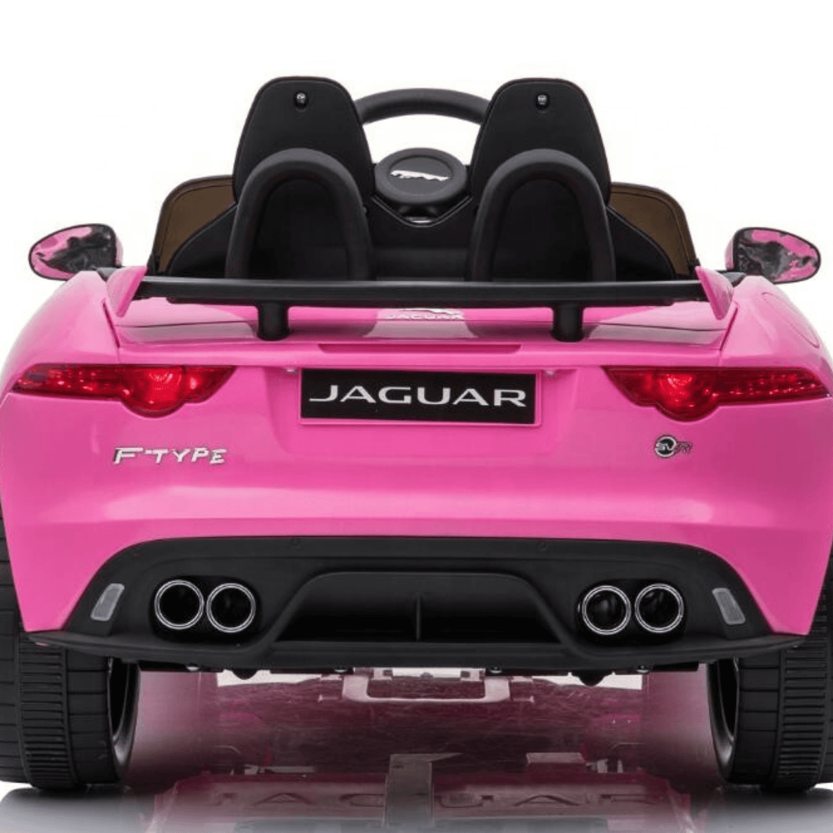 Rear view of the Official 12V Jaguar F-Type Complete Edition Kids Ride-On Car in pink, featuring dual exhaust pipes, logo, black seats, and parental remote control for safety, set against a white background.