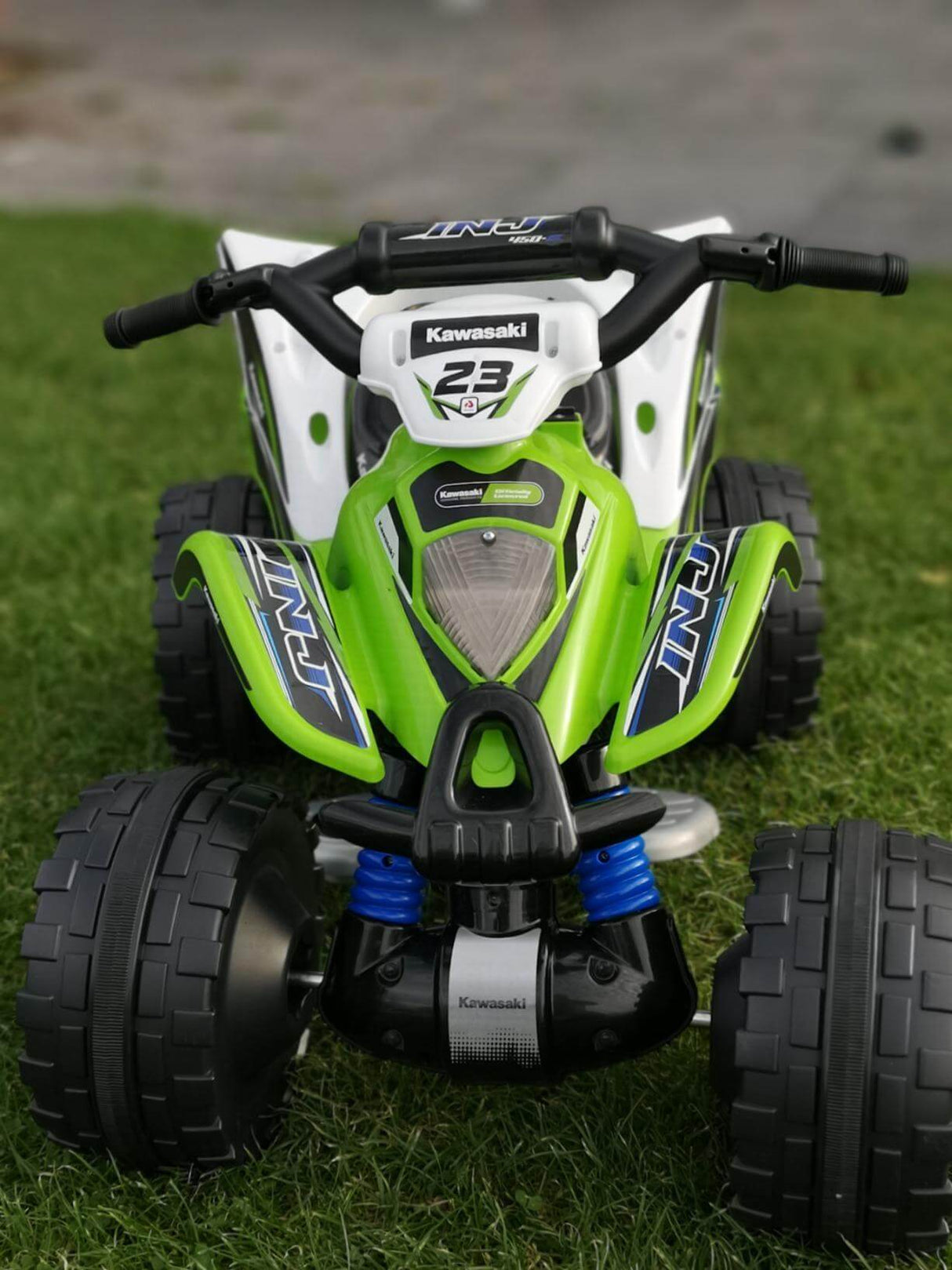 The Green INJUSA Official 12V Kawasaki Ride On Quad/ATV for Kids, decked out with the number 23, features chunky tires and blue suspension details, ideal for off-road fun.