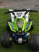 The Green INJUSA Official 12V Kawasaki Ride On Quad/ATV for Kids, decked out with the number 23, features chunky tires and blue suspension details, ideal for off-road fun.