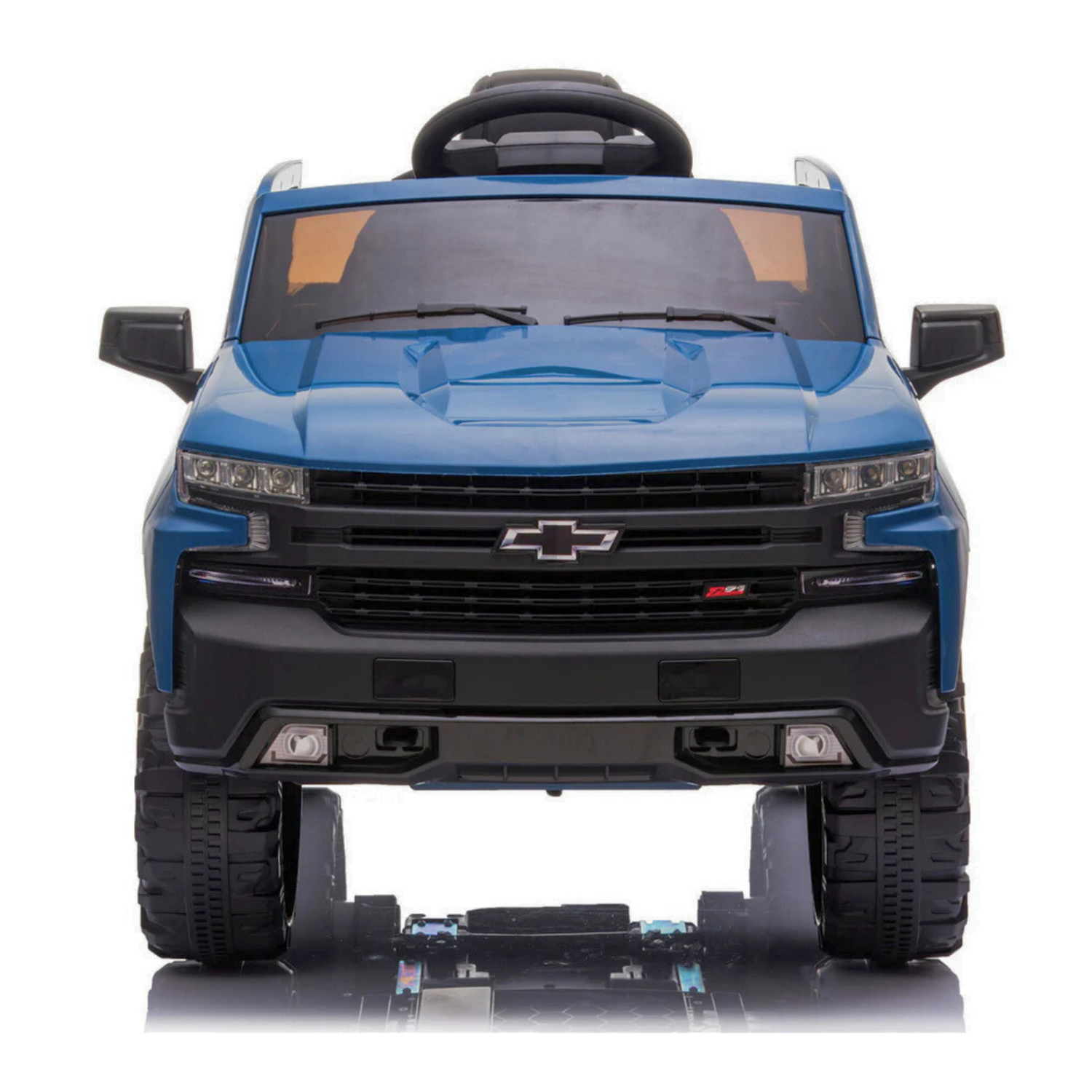 The Blue 12V Chevrolet Silverado Kids Licensed 1 Seater Ride On Truck is viewed from the front, showcasing its detailed grille, headlights, large tires, and interior features like a sporty design and small steering wheel for authenticity.