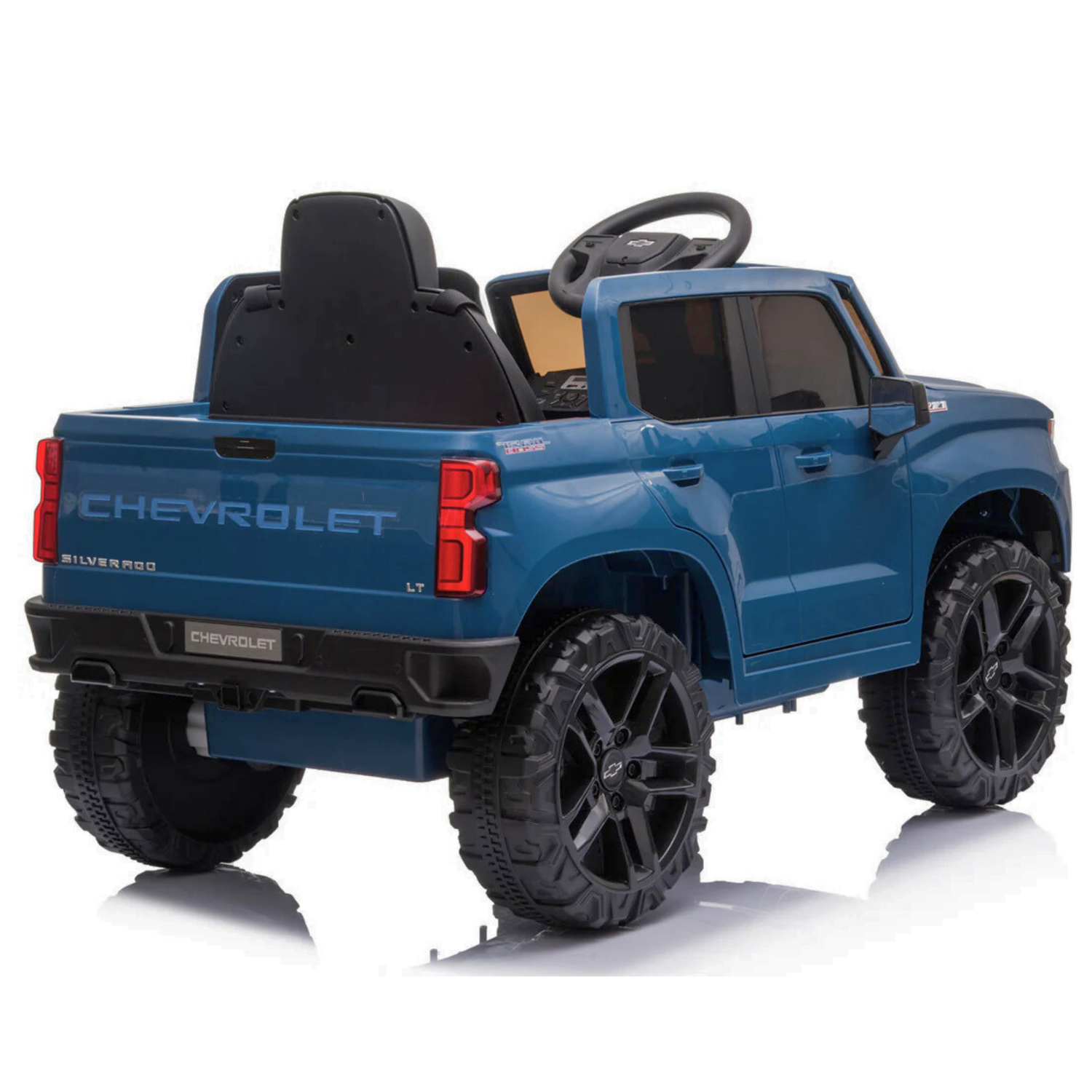The Blue 12V Chevrolet Silverado Kids Licensed 1 Seater Ride On Truck features large black wheels, a visible interior with a steering wheel, music capabilities, and a remote control. Rear side view shows Chevrolet branding and model details.
