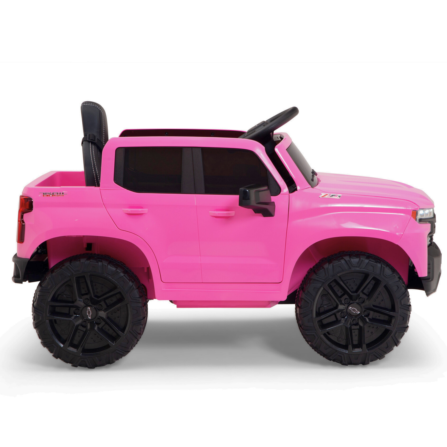 The Pink 12V Chevrolet Silverado Ride-On Truck for kids, with black wheels and off-road design, features a drivers seat, steering wheel, music, and remote control for adventurous rides.