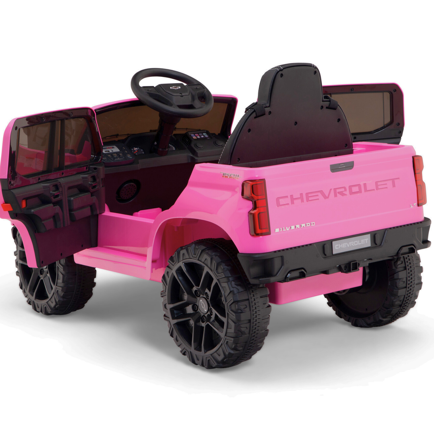 The Pink 12V Chevrolet Silverado Kids Licensed 1 Seater Ride On Truck with black seats and large wheels is shown from the rear-left angle. Doors open to show the steering wheel and dashboard. It can be safely navigated using the Remote Control feature, adding to the fun ride experience.