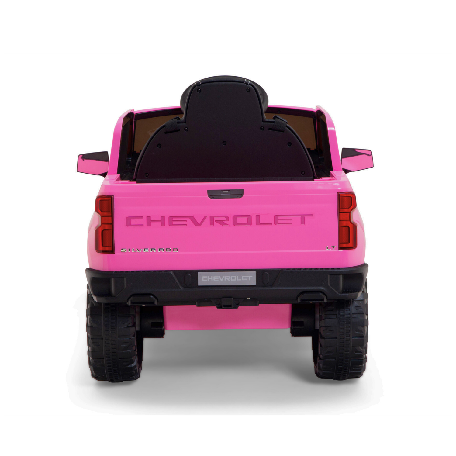 A pink 12V Chevrolet Silverado Kids Licensed 1 Seater Ride On Truck flaunts large black wheels, a visible Chevrolet tailgate, and a dark seat, integrating fun and style.