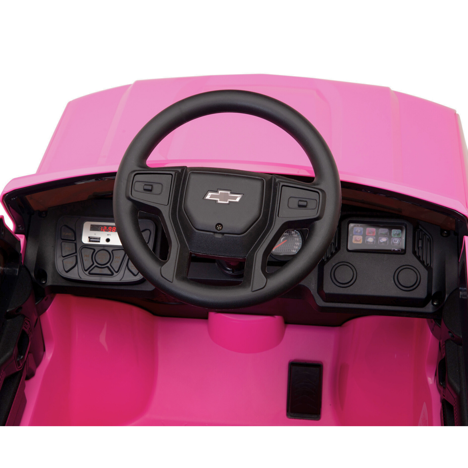 The Pink 12V Chevrolet Silverado Kids Licensed 1 Seater Ride On Truck features a pink interior, black steering wheel with the iconic logo, control panel with buttons and dials, and a digital display on the left. Perfect for kids who dream of their own ride-on car.