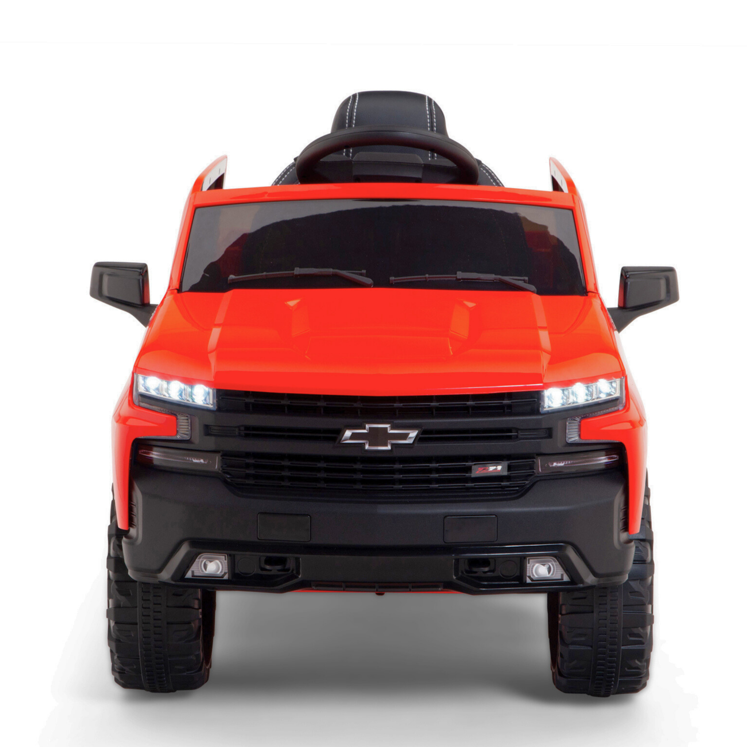 Introducing the Red 12V Chevrolet Silverado Kids Licensed 1 Seater Ride On Truck with Music and Remote: a ride-on car styled like a red pickup truck featuring a black grille, LED headlights, large wheels, steering wheel, detailed interior, and remote control for extra fun.