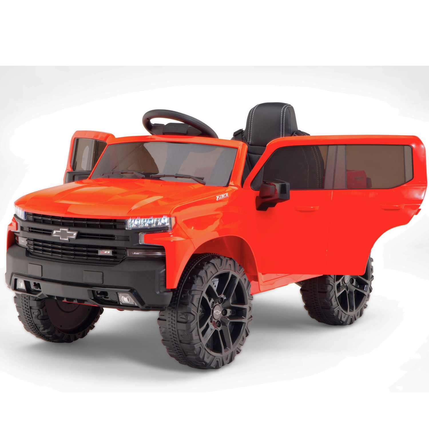 The Red 12V Chevrolet Silverado Kids Licensed Ride-On Truck has an open drivers door, large black wheels, dark tinted windows, a steering wheel, and a black grille with a silver emblem. It includes remote control for added convenience.