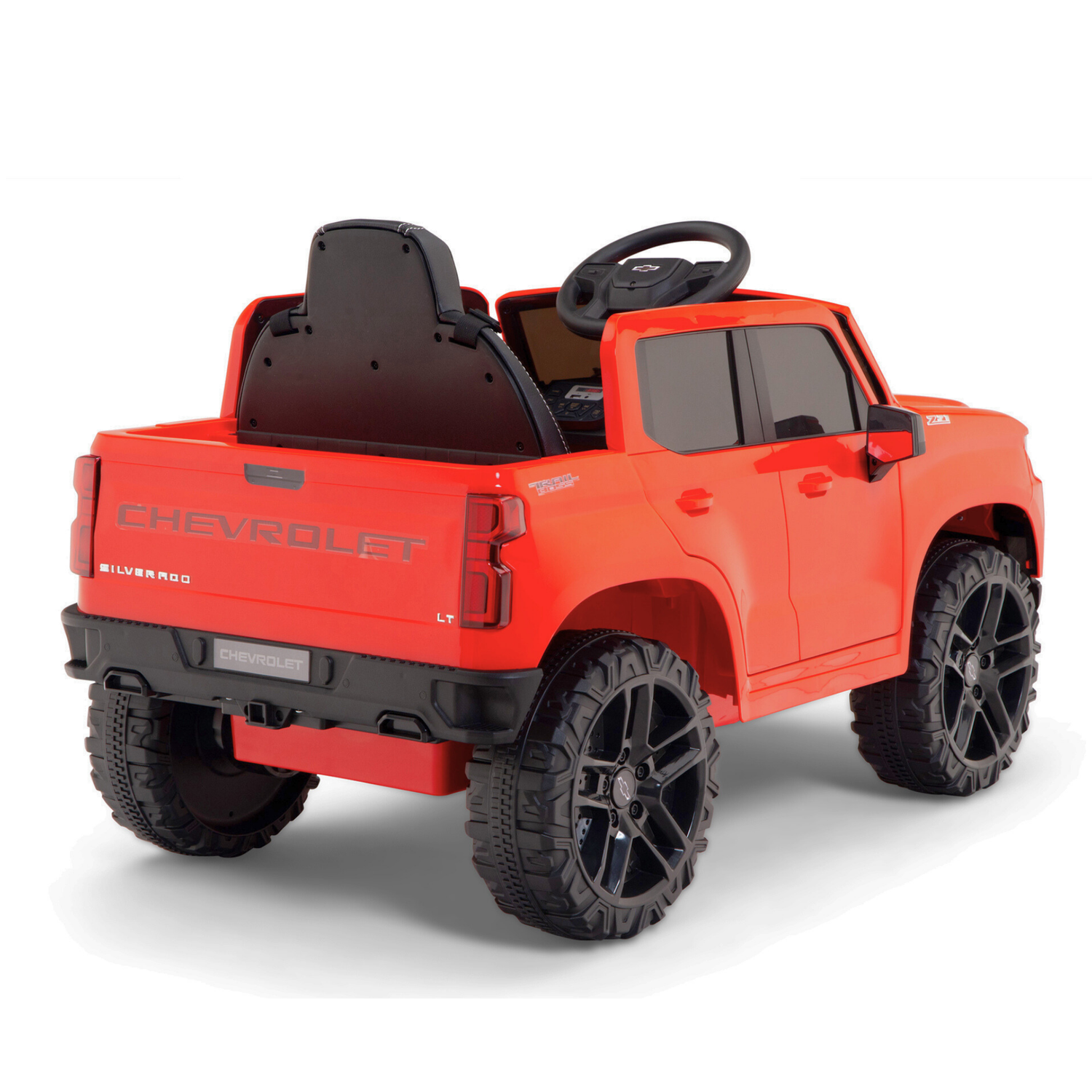 The Red 12V Chevrolet Silverado Kids Licensed 1 Seater Ride-On Truck with Music and Remote is shown from the back, featuring detailed tires, a distinctive front and back design, an open drivers seat with a steering wheel for added fun.