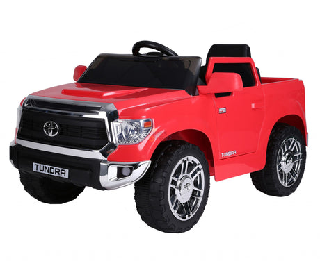 The Red 12V Licensed Upgraded Toyota Tundra 1 Seater Kids Ride On Truck features a black steering wheel, silver accents, large black tires, a shiny front grille, and includes a parental remote control for added safety.