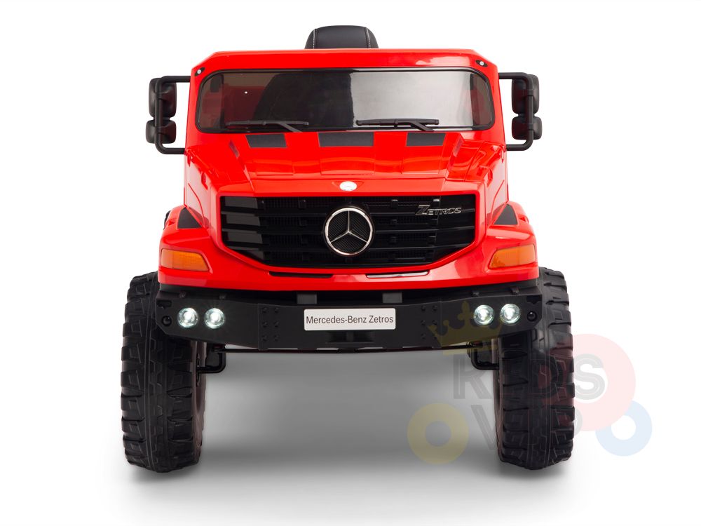 The Red 12V Mercedes Benz Zetros Kids 1 Seater Ride On Truck, shown from the front with rubber wheels, detailed grille, emblem, side mirrors, and headlights, can include a parental remote for enhanced safety and control during playtime adventures.