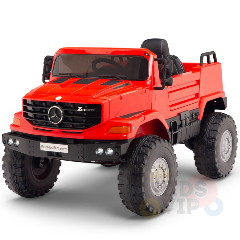 The Red 12V Mercedes Benz Zetros Kids 1 Seater Ride On Truck features a large open cabin with visible seating, rugged rubber wheels, and the iconic front grille logo. It comes with a parental remote for safe playtime adventures.