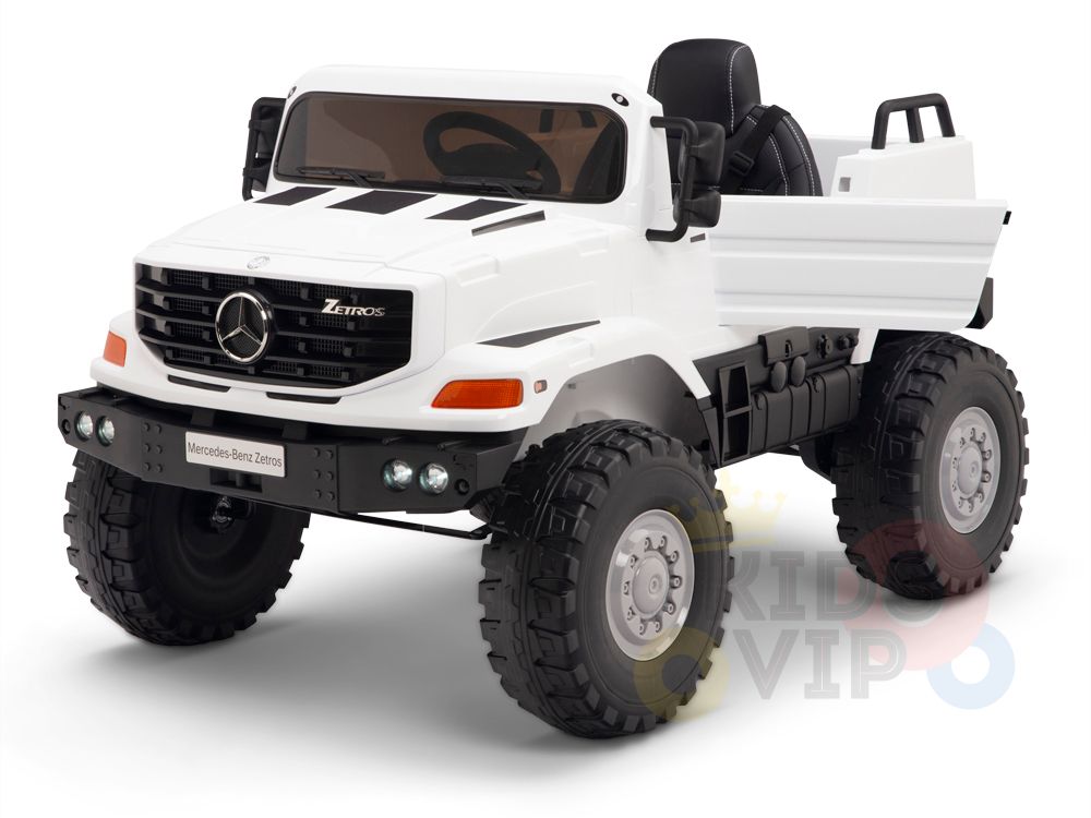 The White 12V Mercedes Benz Zetros Kids 1 Seater Ride On Truck features rubber wheels, realistic headlights, a front grille with the Mercedes emblem, and a spacious cargo area for extra fun.