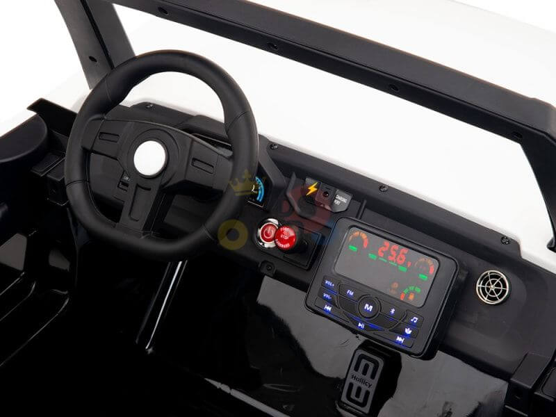 Close-up of a toy car dashboard in the White 24V/4X4 Dune Buggy Ride On UTV with a black steering wheel, red buttons, and digital display panel resembling a music interface. The sleek interiors black finish enhances the 24V experience.
.