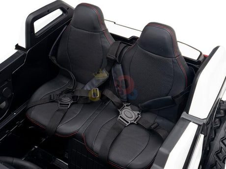 Close-up of black leather seats with red stitching in the White 24V/4X4 Dune Buggy Ride On UTV. These seats, featuring seat belts and a minimalist design, showcase the small-scale craftsmanship perfect for the Kids XXL Edition.