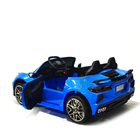 The Kids Premium 24V Blue Corvette C8 Dual-Seater features black leather seats, realistic details like a steering wheel and dashboard, two open doors, shiny chrome EVA wheels, and comes positioned on a white background—ideal for young car enthusiasts.