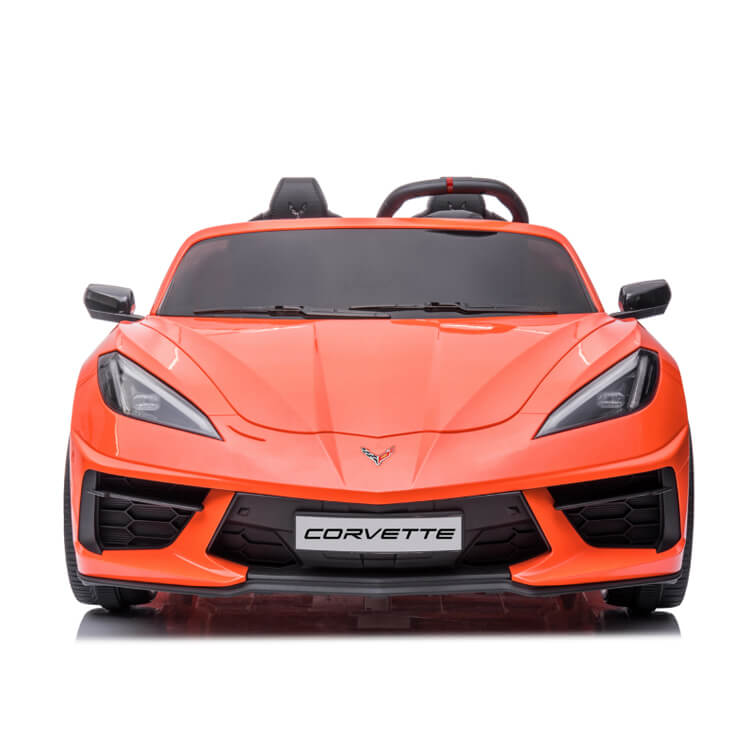 Front view of the Kids Premium 24V Orange Corvette C8 Dual-Seater, showcasing its sleek design with sporty headlights, a black grill, and visible logo; set against a plain white background.