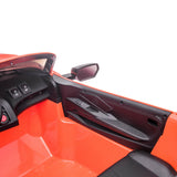 Interior view of the Kids Premium 24V Orange Corvette C8 toy car, showcasing black-detailed dashboard and steering area. Features include side mirrors, a power button, simulated controls, seat and side panel in dual-seater setup with EVA wheels and leather seats.