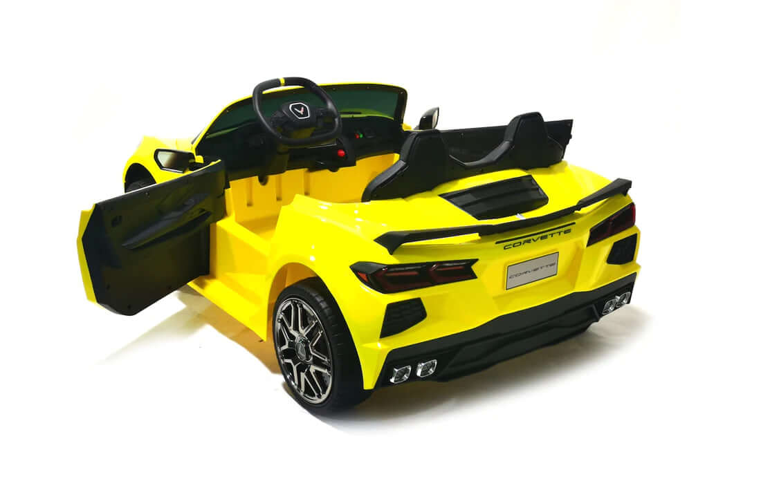 The Kids Premium 24V Yellow Corvette C8 Dual-Seater is a vibrant toy convertible with sleek design, featuring open doors, black leather seats, EVA wheels, chrome accents, and detailed steering against a white background for a sporty elegance.