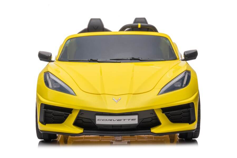 Front view of Kids Premium 24V Yellow Corvette C8 Dual-Seater highlighted by sleek angular design, EVA wheels, low profile, aerodynamic curves, sharp headlights, and leather seats with a Corvette badge on the grille.