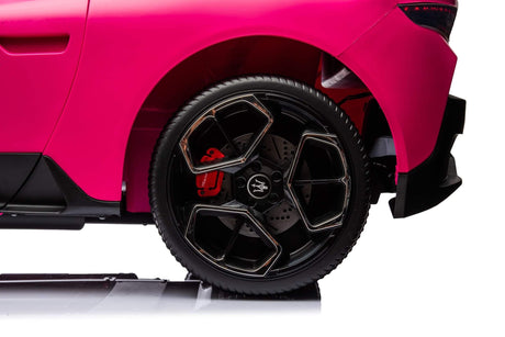 Close-up of the Maserati MC20s rear wheel: featuring an angular black and silver rim design with a striking red brake caliper. The scene captures the luxurious elegance of the Experience Luxury Pink XXL 24V/105W Maserati MC20, set against a plain white background.