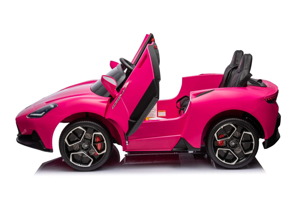 The pink XXL Maserati MC20 ride-on toy car features open scissor doors, sporty design, black leather seats, and black/silver wheels with red accents. Its designed as a luxury 2-seater with RC and rubber tires, displayed on a white reflective background.