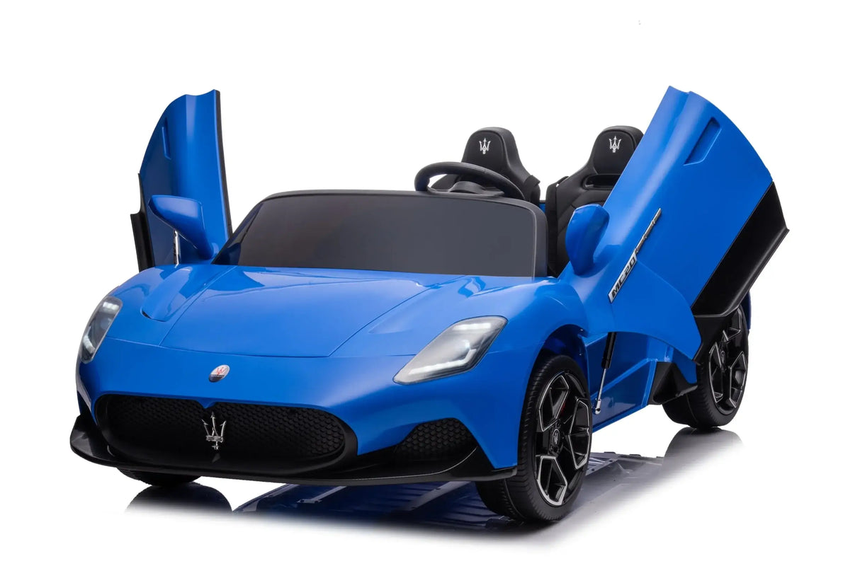 The Experience Luxury: Blue XXL 24V/105W Maserati MC20 toy car features detailed design with raised butterfly doors, a black interior, steering wheel, and shiny black alloy wheels. It includes premium leather seats and rubber tires, showcased beautifully against a neutral white background.