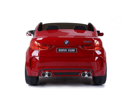 Rear view of a red 12V Licensed XXL BMW X6 Ride On Car with detailed taillights, dual exhausts, and BMW badge. Set against a white background, this car is perfect for kids seeking remote control adventures with their own BMW X6.