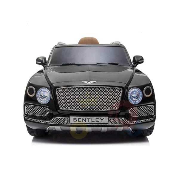The Black Licensed Bentley Bentayga Complete Edition 12V Kids Ride On Car features a chrome grille with the Bentley logo, large circular headlights, and a luxurious brown leather seat interior visible through the windshield, set against a crisp white background.