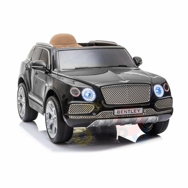 The Black Licensed Bentley Bentayga Complete Edition 12V Kids Ride On Car features realistic details like headlights, a front grille, and Bentley branding. It has silver wheels and a tan leather seat, resembling a luxury SUV. A parental remote is included for safe supervision.