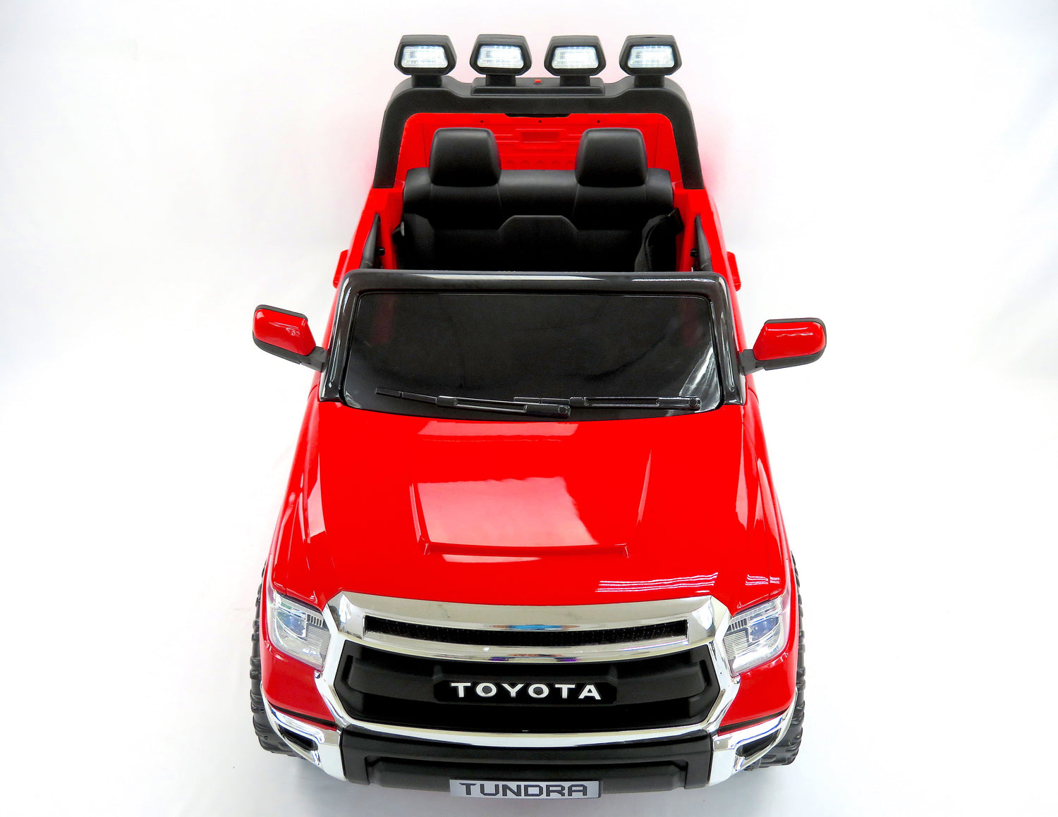 The Red 12v Licensed Toyota Tundra, a 2-seater kids ride-on truck, stands out with front lights and a shiny chrome grille on a clean white backdrop.