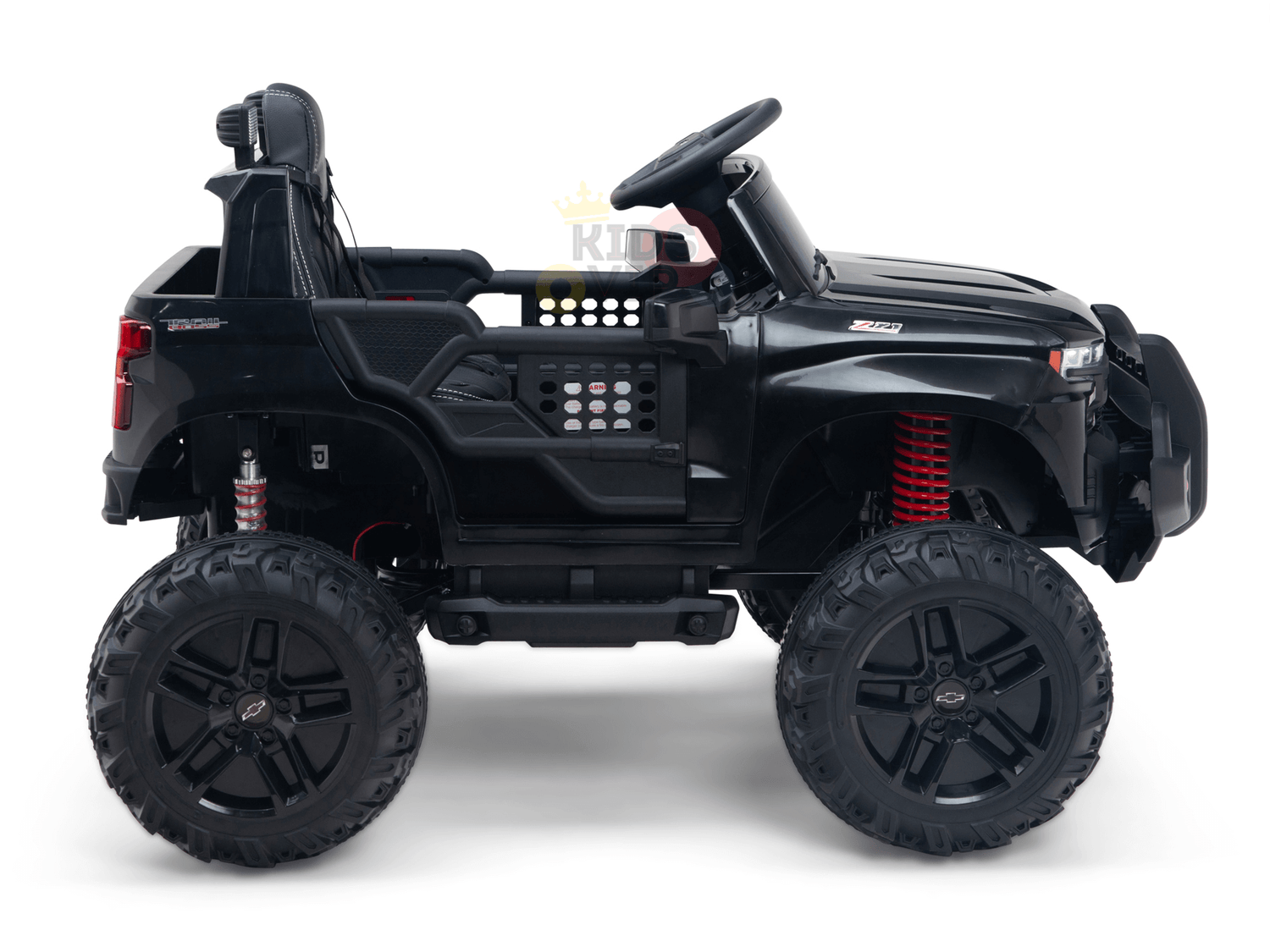 The Black Official 24V Chevrolet Silverado Lifted Kids Ride-on Truck features off-road wheels, red suspension springs, a seat, steering wheel, dashboard for kids, and rugged open sides to emulate a real off-road vehicle.
