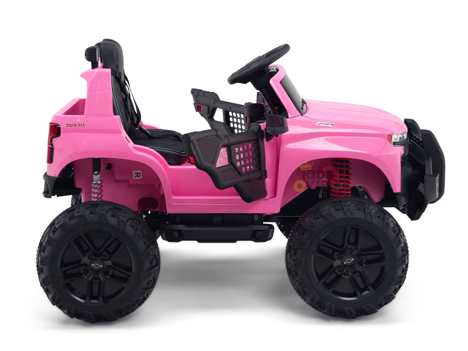 The Pink 24V Chevrolet Silverado Kids Licensed 1 Seater Ride On Lifted Truck features large black wheels, a steering wheel, an open cabin with a single black seat, realistic detailing like suspension springs, and promises thrilling off-road adventures.