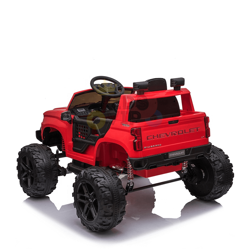 The Red 24V Chevrolet Silverado Kids Licensed 1 Seater Ride On Lifted Truck showcases oversized black wheels and an open-top design, with a visible steering wheel and detailed interior. Photographed from the rear on a white background, its perfect for children.